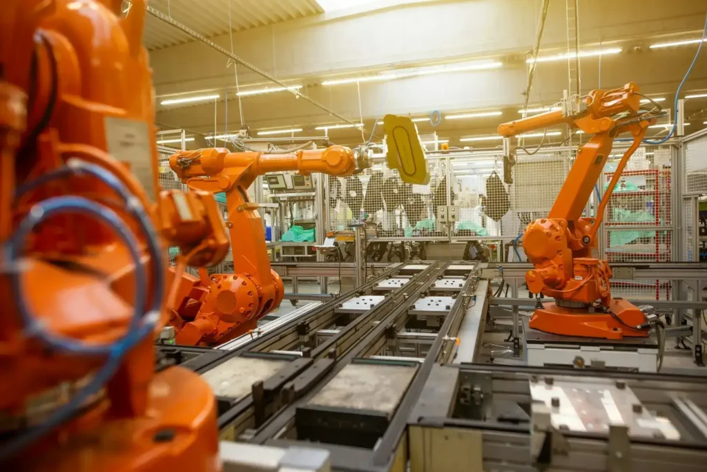 Robots working collaboratively in a factory setting, demonstrating real-world applications of reinforcement learning.