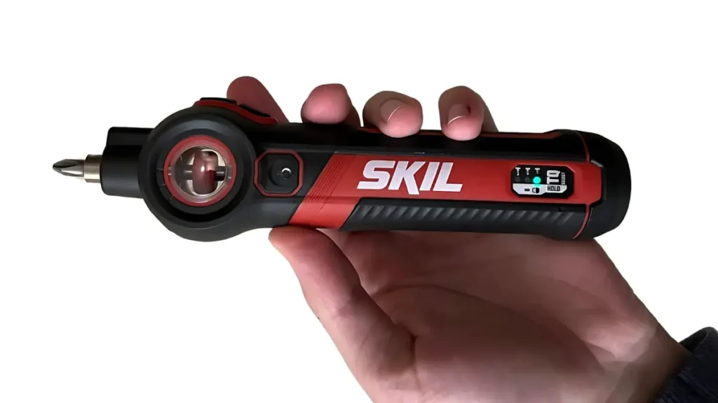 A hand is shown holding the black and red SKIL Twist 2.0 Rechargeable 4V Screwdriver against a white background. The SKIL logo is visible on the side of the tool. Published on Tool Tested.