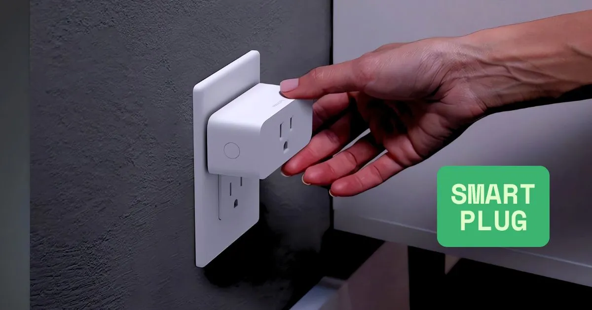 A hand plugging the white Philips Hue Smart Plug into a wall outlet, demonstrating its simple setup for smart home lighting control.