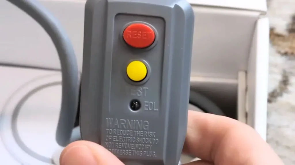 A close-up of the GFCI safety plug on the L'Oréal AirLight Pro's power cord, showing the test and reset buttons.