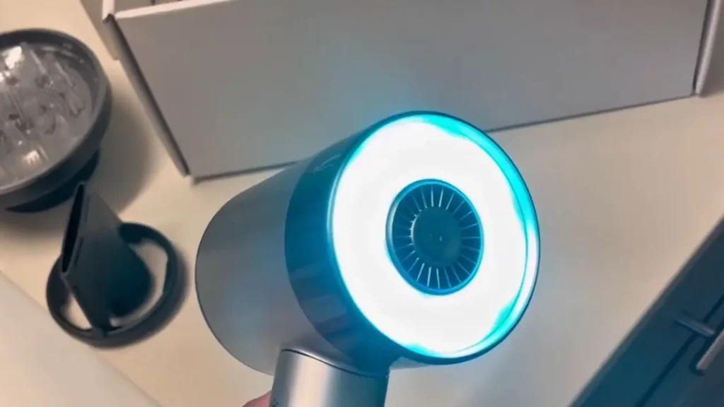A close-up of the L'Oréal AirLight Pro showing its glowing blue infrared light technology.