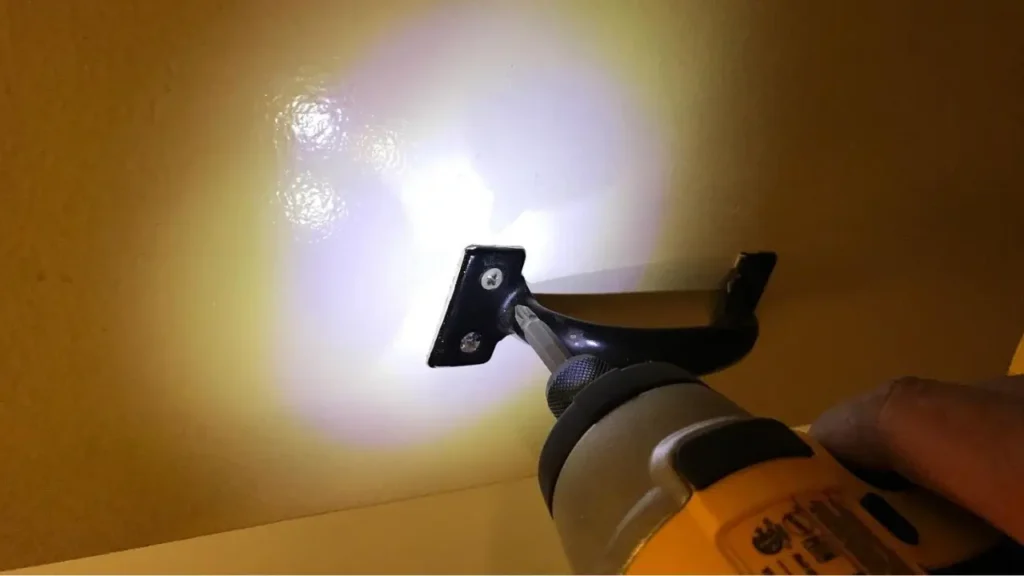 The bright 3-LED light ring on the DEWALT DCF885 impact driver lighting up a dark space.