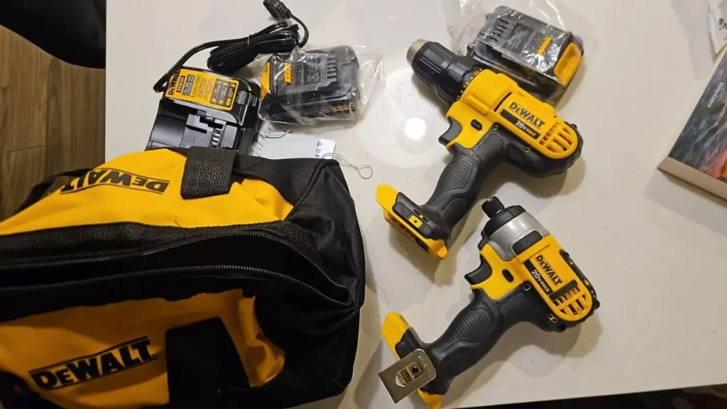 All tools and accessories included in the DEWALT DCK240C2 kit laid out on a table.