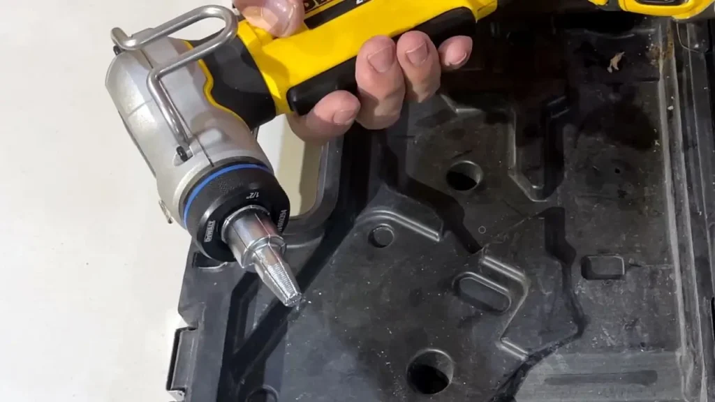 A plumber's hand holds the DEWALT PEX Expander DCE400D2 with its bright LED light shining, showing the tool's head and illumination. This is for Smart AI Gears.