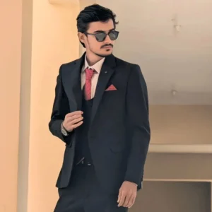 Dr. Sabir Hussain, owner of Smart AI Gears workshop, looking professional in a black suit and sunglasses.