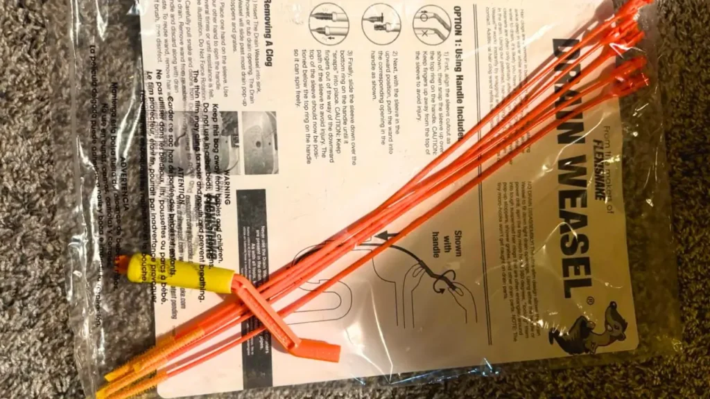 Packaging of the Drain Weasel starter kit, clearly showing the handle and disposable wands ready to tackle hair clogs.