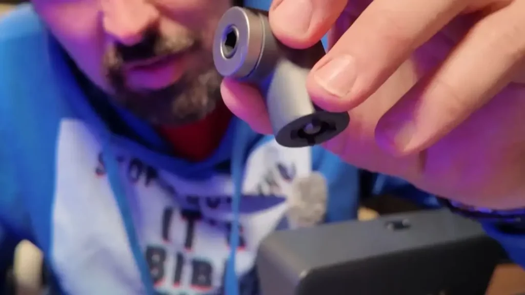 A person holding and showing the 90-degree angle helper from the Fanttik S2 Pro kit.