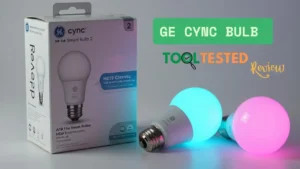 GE Cync bulb HD+ Smart Bulb 2 retail box alongside two A19 smart bulbs, one glowing bright cyan and the other vibrant magenta, for Smart AI Gears review.