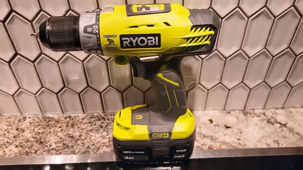 Smart AI Gears: Ryobi Hammer Drill, a bright green and black Ryobi ONE+ HP Brushless 1/2 inch hammer drill (PBLHM101B) with a 4Ah 18V Lithium battery, placed on a kitchen counter with white hexagonal tiles in the background. Natural lighting.
