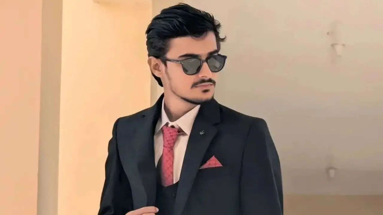 Sabir, founder of Smart AI gears, wearing a dark suit and sunglasses, looking to the side.
