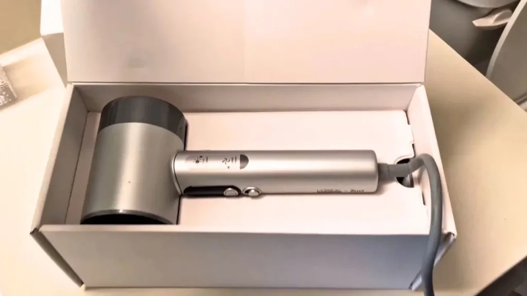 The L'Oréal AirLight Pro hair dryer sitting inside its white packaging box.