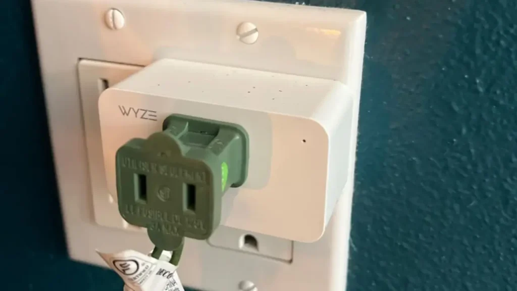 Wyze Plug in wall with another plug, showing it doesn't block the outlet.