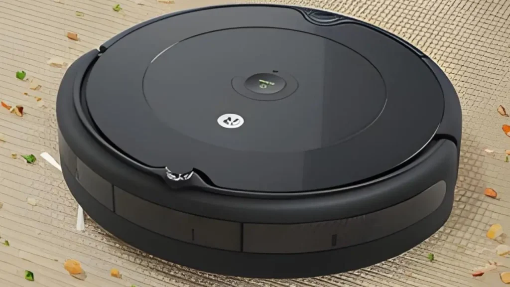 The iRobot Roomba 694 robot vacuum with its tangle-free rubber brushes on a carpet with pet hair.