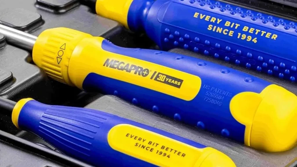 Close-up of Megapro 13-in-1 multi-bit screwdrivers with blue and yellow ergonomic handles and 30th anniversary branding