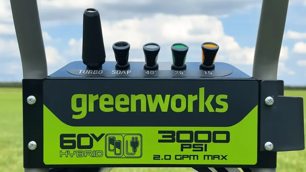 A close-up of the Greenworks 3000 PSI pressure washer's control panel and its convenient onboard storage for the five included spray nozzles.