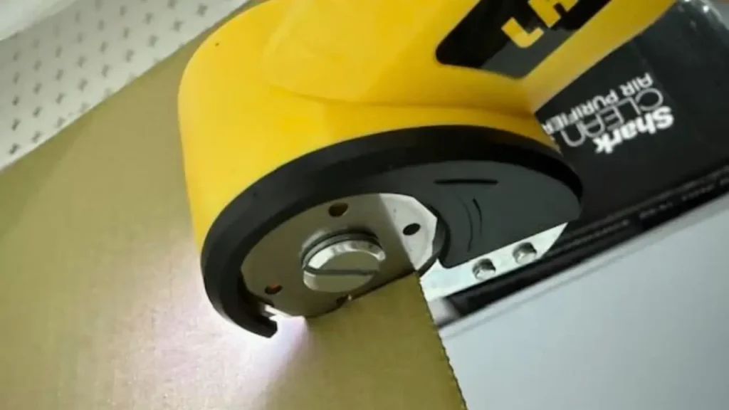 Close-up of blade cutting cardboard