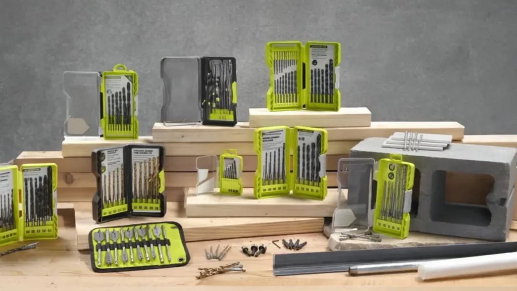 Ryobi drill and bit sets organized in clear, yellow plastic cases, showcasing a variety of sizes for versatile drilling tasks, with wooden and concrete platforms as the backdrop.