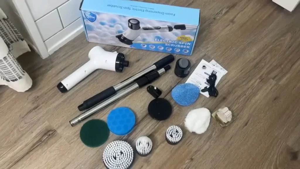 Full view of the $19 Electric Spin Scrubber with various brush heads, extension rods, and other accessories laid out in the unboxing.