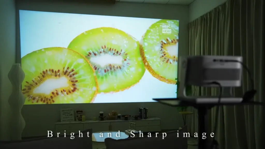 The VOPLLS projector screen displaying a bright, sharp, and colorful image of sliced kiwi.
