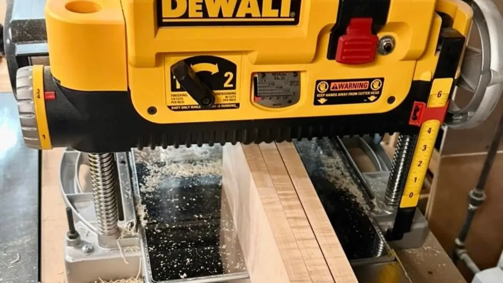 The DEWALT DW735X thickness planer is shown in a workshop, actively smoothing a wooden board.