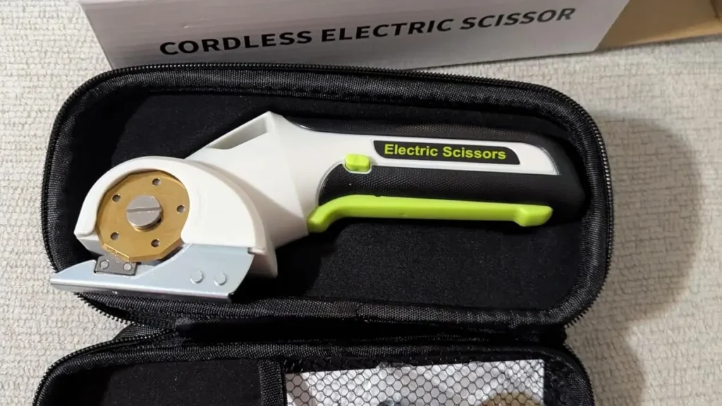 The EXPEDMAN electric scissors and charging cable inside their black storage case.