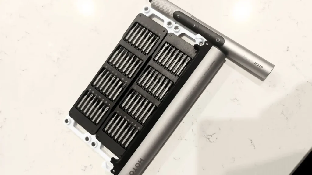 A top-down view of the HOTO tools SNAPBLOQ S-A01 precision electric screwdriver and its comprehensive bit set for your electronics and gadget repair, reviewed by Smart AI Gears.