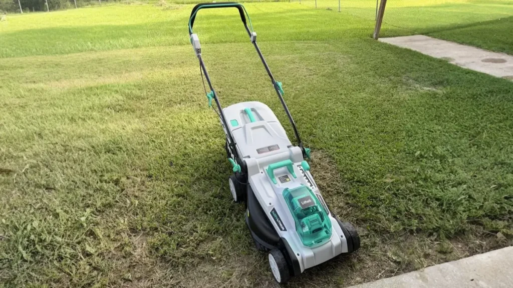 A Litheli 40V cordless lawn mower sitting on a lawn, showing the battery compartment.