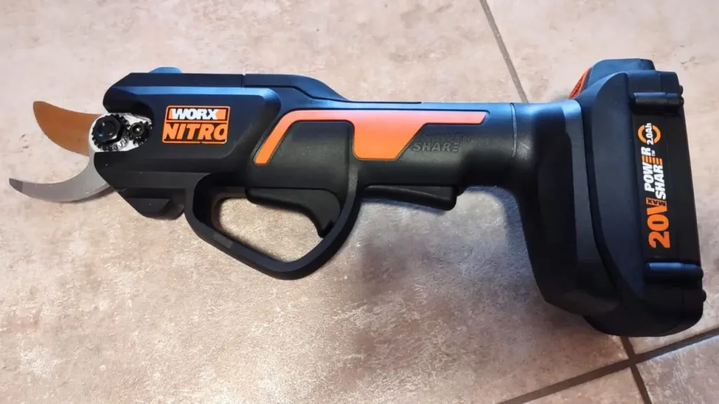 The easy-to-grip Worx WG330 cordless pruner with a 20V PowerShare battery attached.