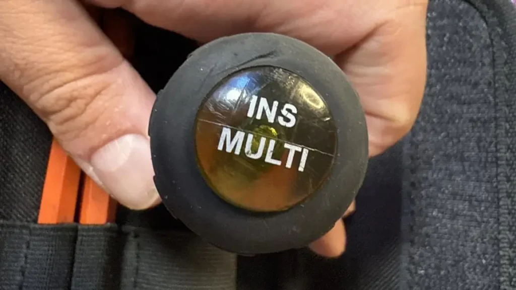 A close-up of the black and orange cushion-grip handle of the Klein Tools 32288, highlighting the "INS MULTI" text.