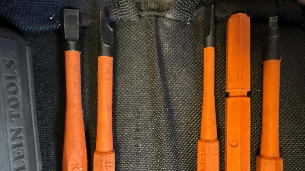 A view of the Klein 32288's bright orange insulated blades stored in their canvas roll pouch.