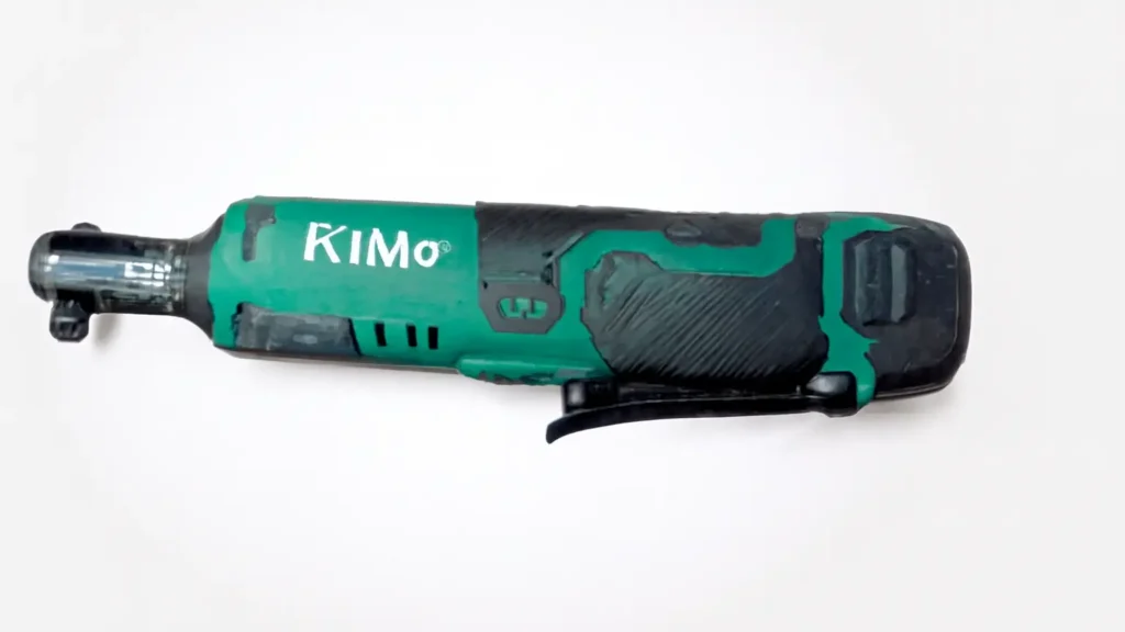 A close-up side view of the KIMO 12V cordless ratchet, showing its green and black body and comfortable rubber-coated grip.