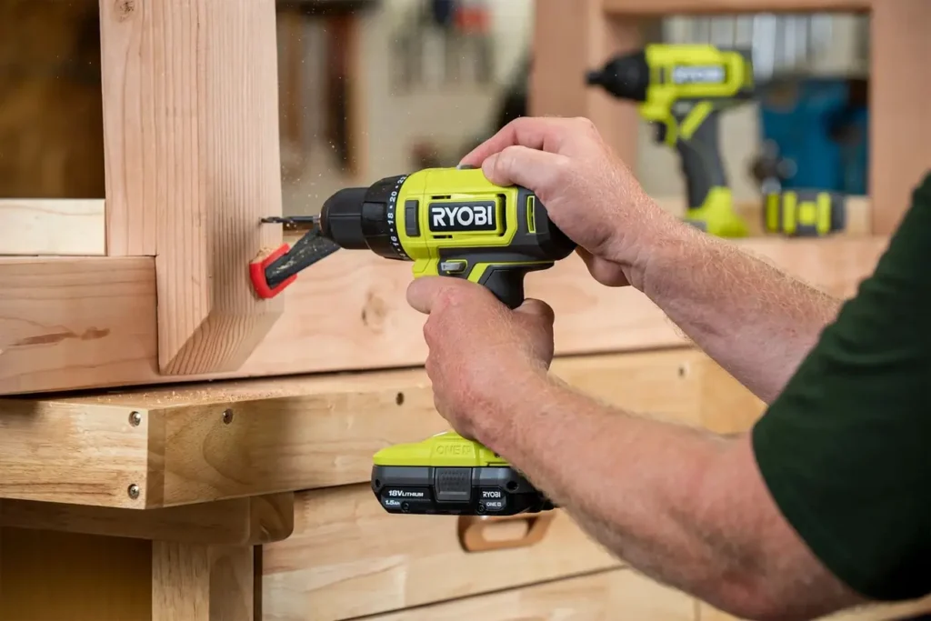 A user drilling a screw into wood with the Ryobi PCL206K2 18V cordless drill/driver.