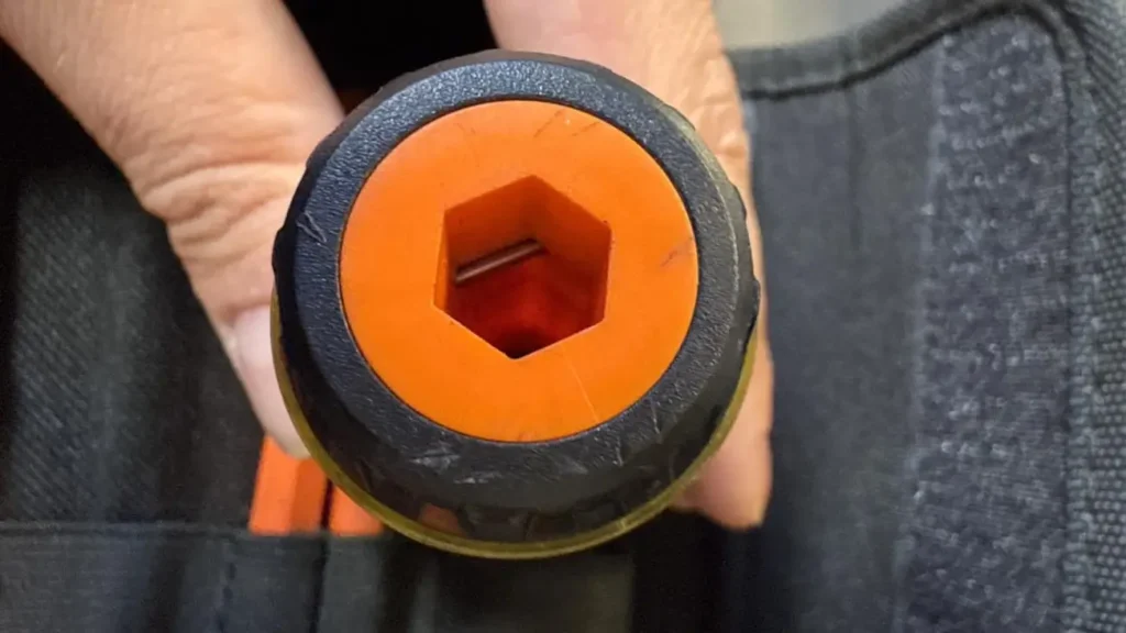 A top-down close-up of the Klein Tools 32288's handle, showing the hexagonal slot for the blade and the orange inner core.