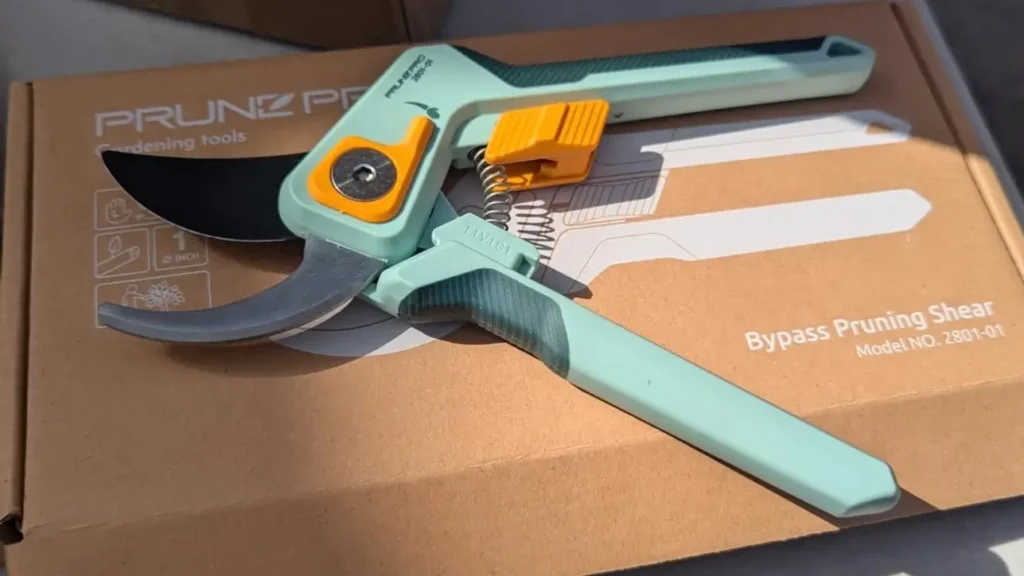 A close-up shot of the PrunePro Pruning Shears in their box, clearly showing the product and its packaging. The tool is a featured review on the Smart AI Gears website.