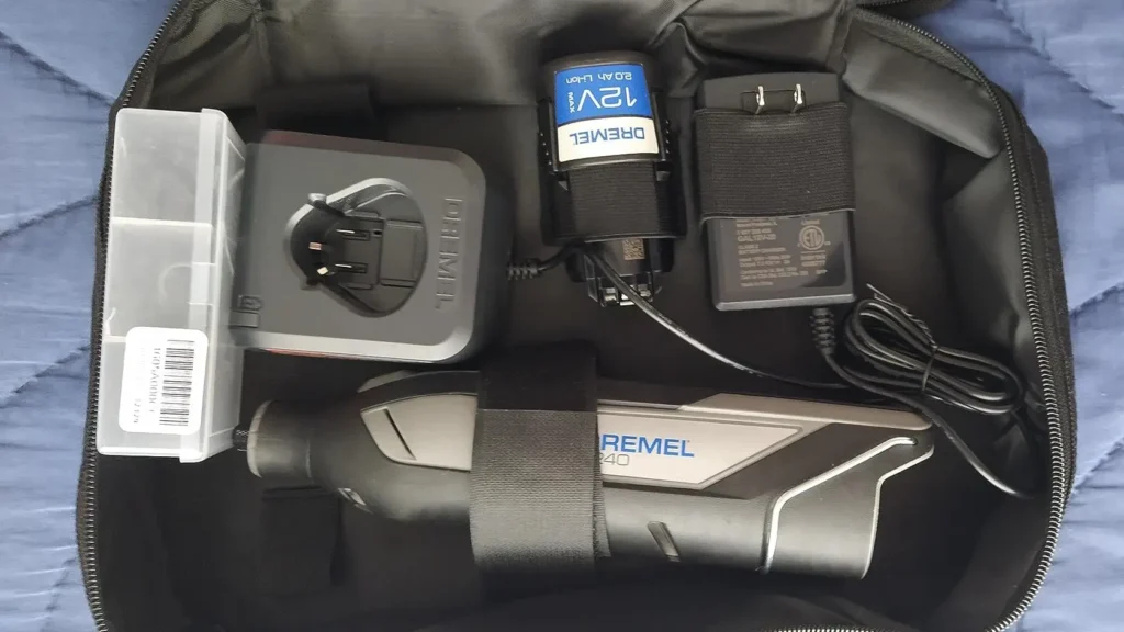 An open view of the Dremel 8240 soft storage case with the battery, tool, and charger securely organized.