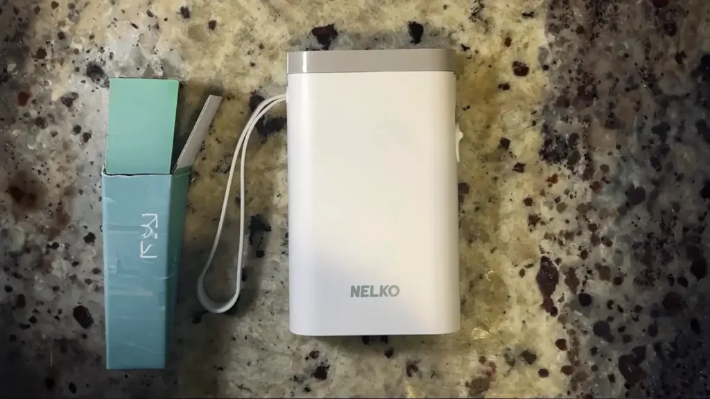 A white Nelko P21 Bluetooth label printer and its original packaging on a countertop, a top choice for Smart AI Gears home organization.