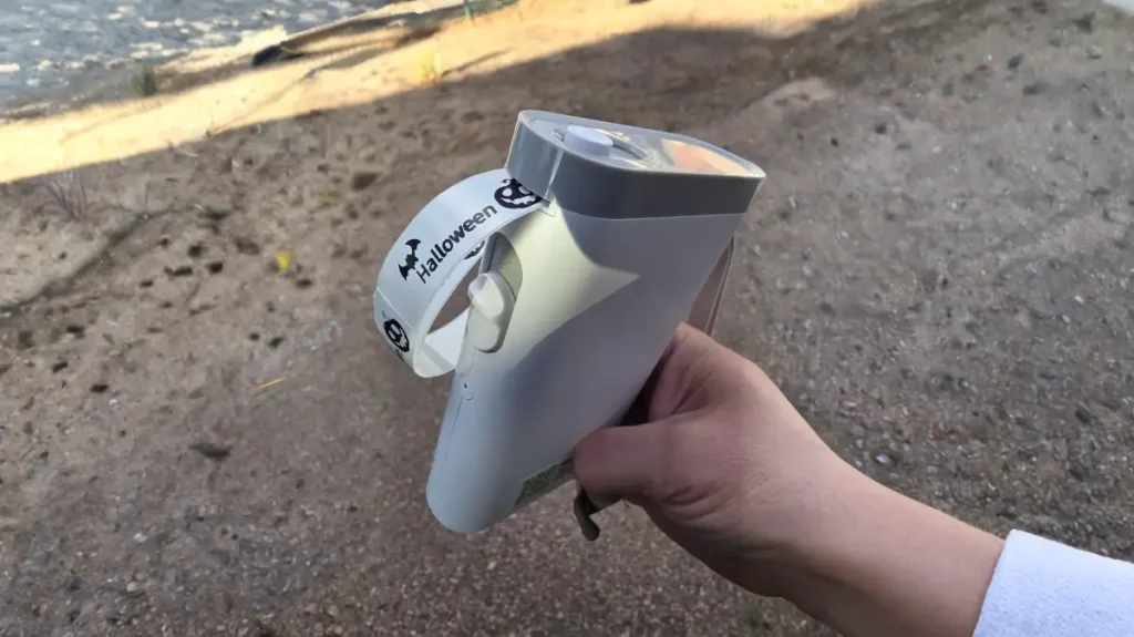 A person holding the lightweight Nelko P21 label maker, demonstrating its portable pocket-sized design.