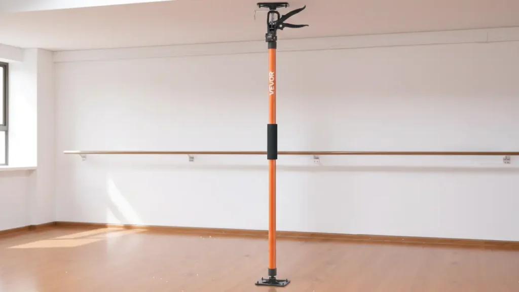 A single orange VEVOR telescoping support pole extended from floor to ceiling in a bright, modern room with wooden floors.