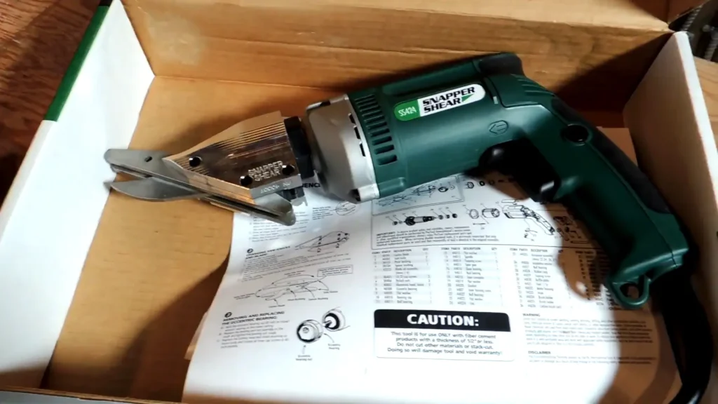 Angled view of PacTool SS724 cutting fiber cement board, showing minimal debris.