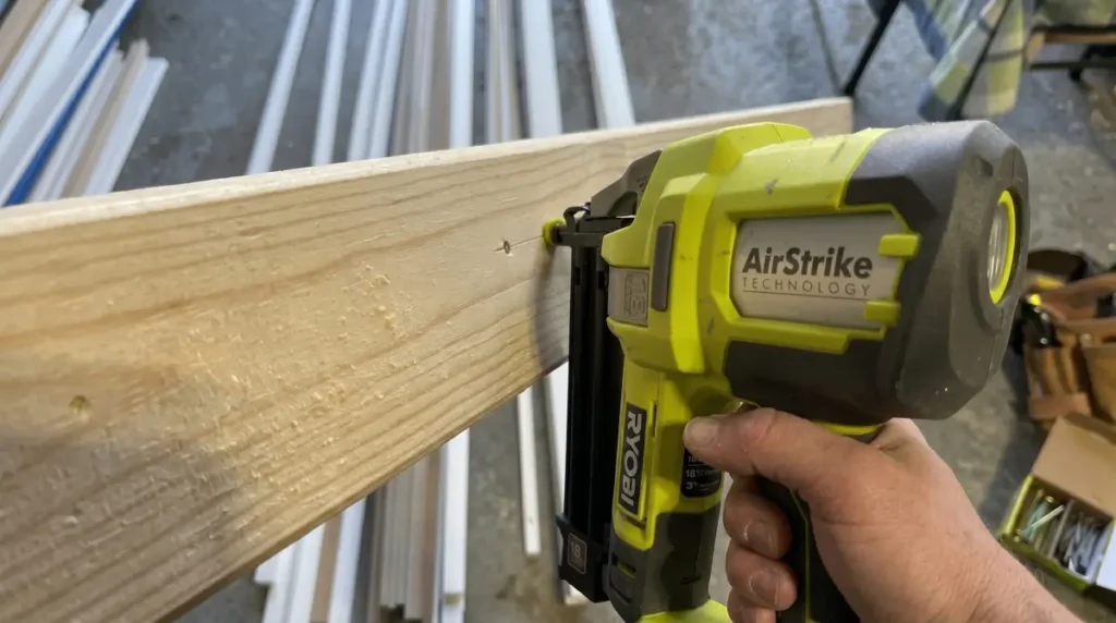 Ryobi P321 Cordless 18-Gauge Brad Nailer driving a nail into white pine for smartaigears.com.