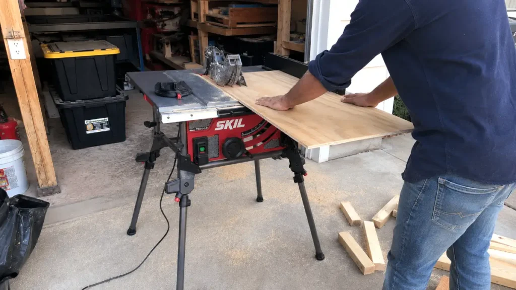 Cutting a thick sheet of plywood using the SKIL portable table saw with the fence locked in.
