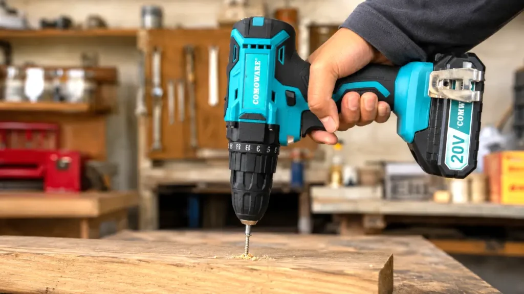 Driving a 3-inch deck screw into pressure-treated wood using a cordless drill motor.