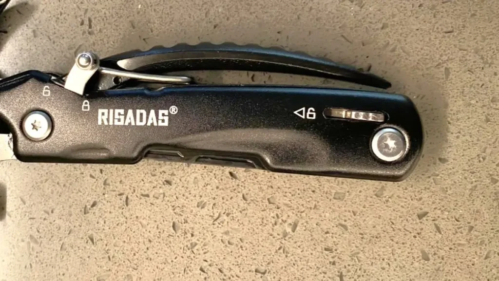 Close-up of the safety locking mechanism on the Risadas multitool.